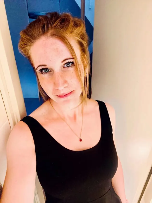 Photograph of Ariel Salminen smiling in a black dress.